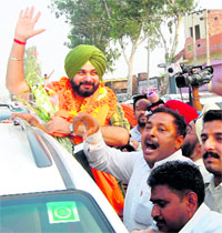 BJP MP Navjot Singh Sidhu gets a warm welcome from party workers on his arrival in Amritsar on Saturday.