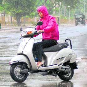 A girl enjoys the drizzle in Mohali