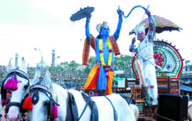 Actors dressed up as Krishna and Arjun show their martial skills during a rath yatra organised by the Maharshi Valmiki Janmotsav Committee near Red Fort in New Delhi to mark Balmiki Jayanti on Sunday.