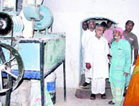 Union Rural Development Minister CP Joshi inspects a water mill that generates power, besides its traditional use for grinding wheat in Dehradun on Sunday.