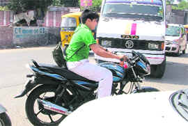 Violating traffic rules, an underage rider negotiates traffic in Ludhiana. 