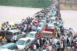 A crowd gathers at the Nagarjuna Sagar dam to watch the floodwater gushing out, in Hyderabad