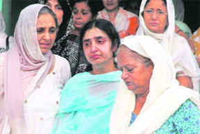 Ranjna Joshi, the widow of Sri Lankan pilot Raman Joshi (centre), being consoled by her relatives in Jalandhar on Sunday.