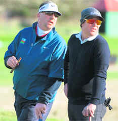 Australian cricketer Shane Warne (R) and former English cricketer Sir Ian Botham during the third round of the Alfred Dunhill Golf Championship at Carnoustie in Scotland, on Sunday.
