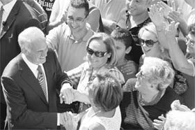 Greek socialist PASOK party leader Giorgos Papandreou greets his supporters prior to casting his vote for general election in Athens on Sunday.