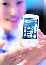A China Telecom hostess shows an Ophone mobile phone at the International Telecommunication Union (ITU) Telecom World 2009 exhibition in Geneva on Monday.