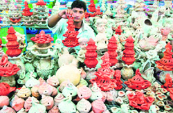 Decorations for Diwali: A vendor puts up earthen lamps for sale for the upcoming festival of lights, at Sector 15, Chandigarh