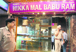 Police officials at the jewellery shop where an alleged cheating incident took place in Sector 22, Chandigarh, 