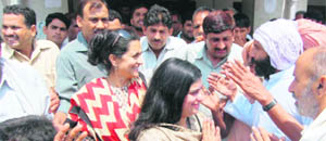  Kiran Choudhry and her daughter Shruti thronged by voters during electioneering on Monday.