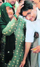 Congress MP from Rohtak Deepender Hooda takes the blessings of an elderrly woman in Karnal on Monday. 