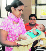 Deepak and Rita Yadav with their son, who developed complications allegedly due to a blunder by a Gurgaon-based doctor