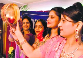 Members of the Gayatri Ladies’ Club participate in Karwa Queen Competition in Ludhiana on Monday.