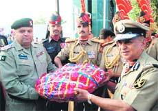 Raman Srivastava, Director-General, BSF (right), hands over a basket of fruit and sweets to Akbar Ali Bhutt of the Pakistan Rangers at the Attari checkpost on Monday. 