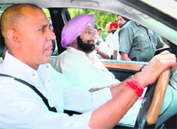 Capt Amarinder Singh with former MLA Arvind Khanna after appearing at the Mohali court in connection with a hearing in the Amritsar Improvement Trust case on Monday. 