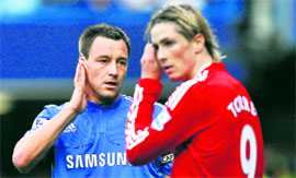Chelseas John Terry (L) keeps his eye on Liverpools Fernando Torres during their match at Stamford Bridge in London on Sunday.
