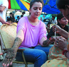 A woman gets a henna design on her palm on the eve of Karva Chauth in New Delhi on Tuesday.