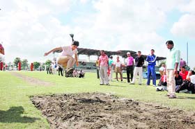 A policewoman participates in the long-jump event at the State Police Athletic Meet in Dehradun