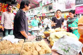 Women buy namkeen and feni at a shop in Dehradun