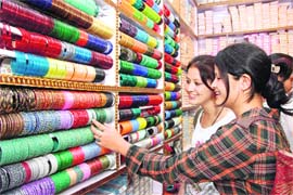 Girls shop for bangles on the eve of Karva Chauth