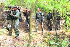 Army jawans carry their colleague, injured during a gun-battle between militants and security forces in the forest area at Ladoo Pampore in district Pulwama, 28 km from Srinagar.