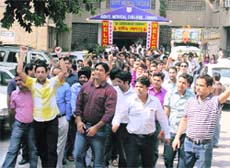 Doctors hold a protest outside the Government Medical College in Jammu on Tuesday.