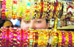 A woman chooses bangles for Karva Chauth in Jammu.
