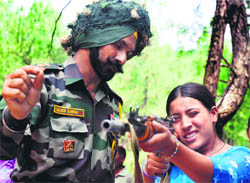 An Army officer trains a VDC girl member how to shoot.