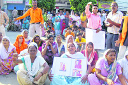 Family members of a youth who committed sucide stage dharna outside the Atam Nagar police post.