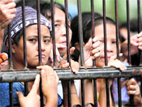 Typhoon survivors wait for relief distribution in Binan, Laguna, south of Manila, on Tuesday.