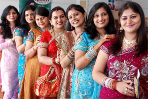 Festive look: Women pose during a function organised on the occasion of Karva Chauth in Bathinda on Wednesday.
