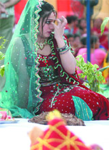 A woman listens to the karva chauth katha in New delhi 