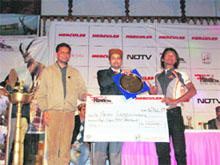 Anurag Thakur, MP, and president of the HPCA, giving away the winners trophy and a cheque for Rs 1.5 lakh to Padam Sabenhang of Nepal, who won the fifth edition of the Hercules Mountain Biking Himachal Championship at Manali on Tuesday.