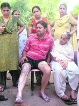 Baldev Raj writhing in pain at the Civil Hospital in Ludhiana on Wednesday. 