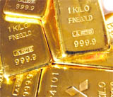 Gold bars are displayed at a branch of Mitsubishi Materials Corporation in Tokyo on Thursday. Gold hit record highs on the spot and futures markets on Thursday, marking historic peaks for the third straight session on continued weakness in the dollar. Spot gold rose as high as $1,050.55 per ounce as of 0118 GMT. US gold futures were at $1,051.60