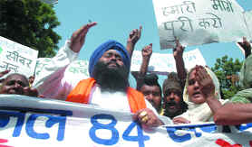 Widows and relatives of Sikhs who were killed in the 1984 riots shout anti-government slogans during a demonstration in New Delhi on Thursday.