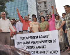 Residents protest against Unitech near Signature Tower in Gurgaon on Thursday. 