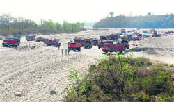 A file photo of trucks ferrying sand and gravel from the Song riverbed near Dehradun.