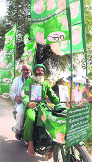INLD supporters canvass support for the party on a motorcycle in the Pundri constituency.