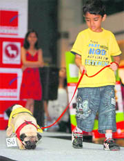 A proud owner walks the ramp with his pet at a mall in Gurgaon.