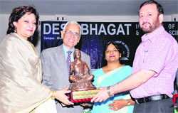 Desh Bhagat group chairman Dr Zora Singh honours a delegate during a seminar at Mandi Gobindgarh