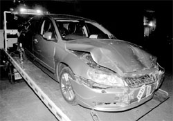 The damaged car being lifted in Sector 15, Chandigarh, on Friday night.