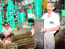 An employee of the factory shows an empty basket at Industrial Area, Phase I, in Chandigarh on Friday.
