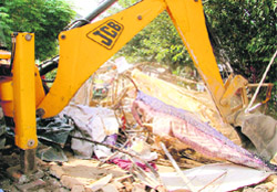 A JCB machine demolishes a shanty in Ludhiana 