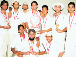 Winners of the inter-college cricket tournament pose with trophy. 