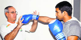 Indian boxing teams Cuban coach B.I. Fernandez works with Olympian Jitender Kumar in Patiala. 