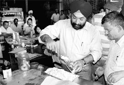 Members of the local health authority and others take samples of sweets during a raid at Khukhrain cold storage and ice factory in Industrial Area, Chandigarh, on Saturday.