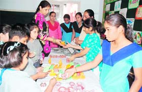 Students of Kainthal School, Patiala, purchasing candles manufactured by deaf and dumb kids from a stall in their school