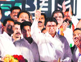 MNS chief Raj Thackeray brandishes a sword at an election rally in Mumbai