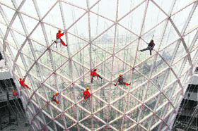 Workers clean the exterior of the "Sun Valley" at the 2010 World Expo site in Shanghai on Sunday. The Shanghai Expo, with the theme of "Better City, Better Life", is scheduled to be held from May 1 to October 31, 2010. So far, 191 nations and 48 international organisations have confirmed their participation in the Expo, Xinhua News Agency reported
