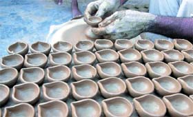 GETTING READY TO FIGHT DARKNESS A potter prepares diyas in New Delhi ahead of Divali